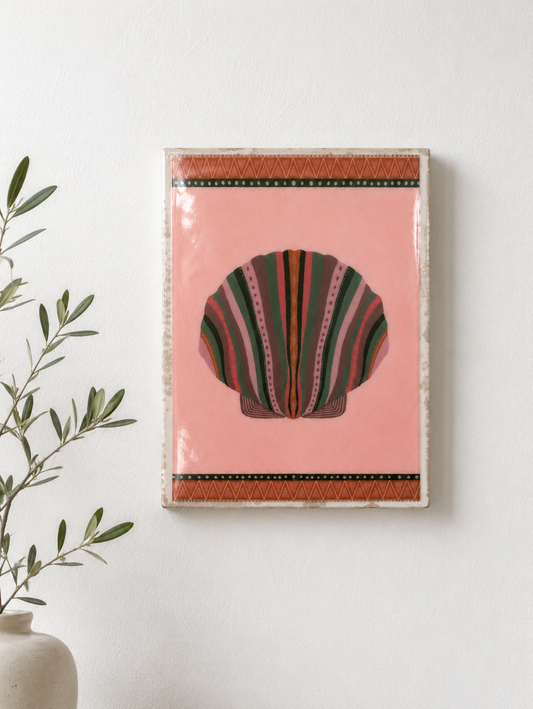 Decorative wall art with a shell design on a pink background, framed in orange.