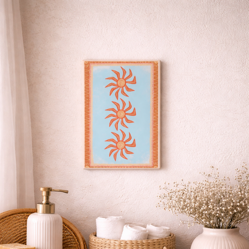 Nautical-themed decor with a framed sun design, baskets, and starfish on a wooden surface.
